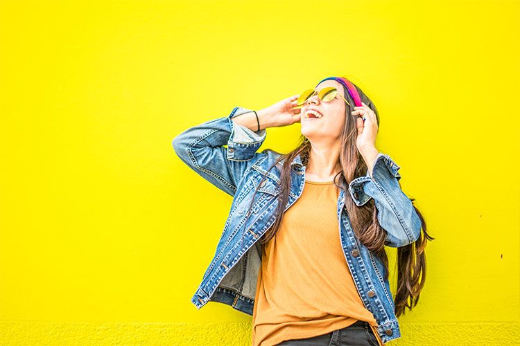 Smiling girl on yellow background