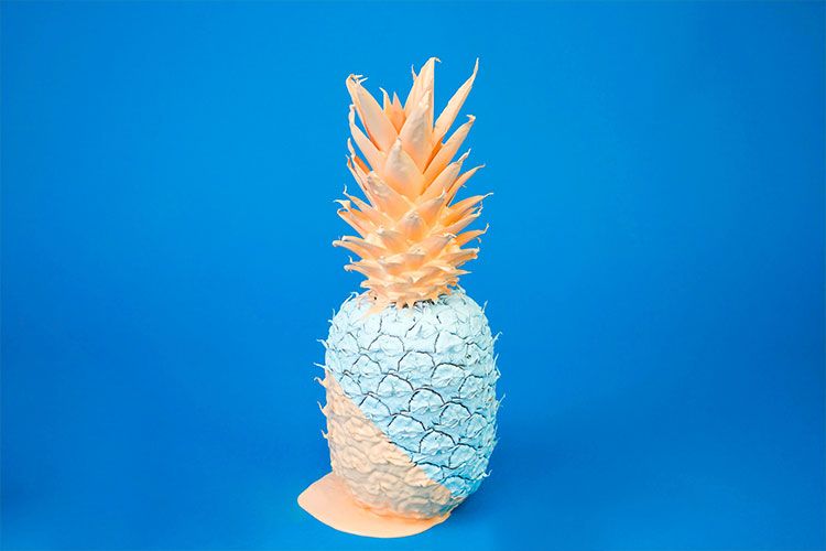 White and yellow pineapple on blue background