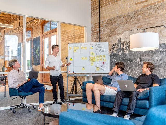 Guy standing next to whiteboard and presenting