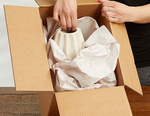 Shipping carton with tissue paper
