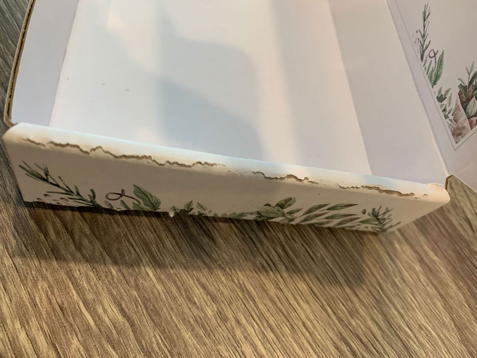 Mailer box with tears in paper