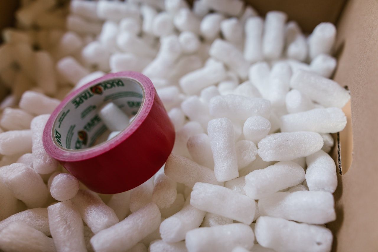 Packing peanuts and tape in a cardboard box